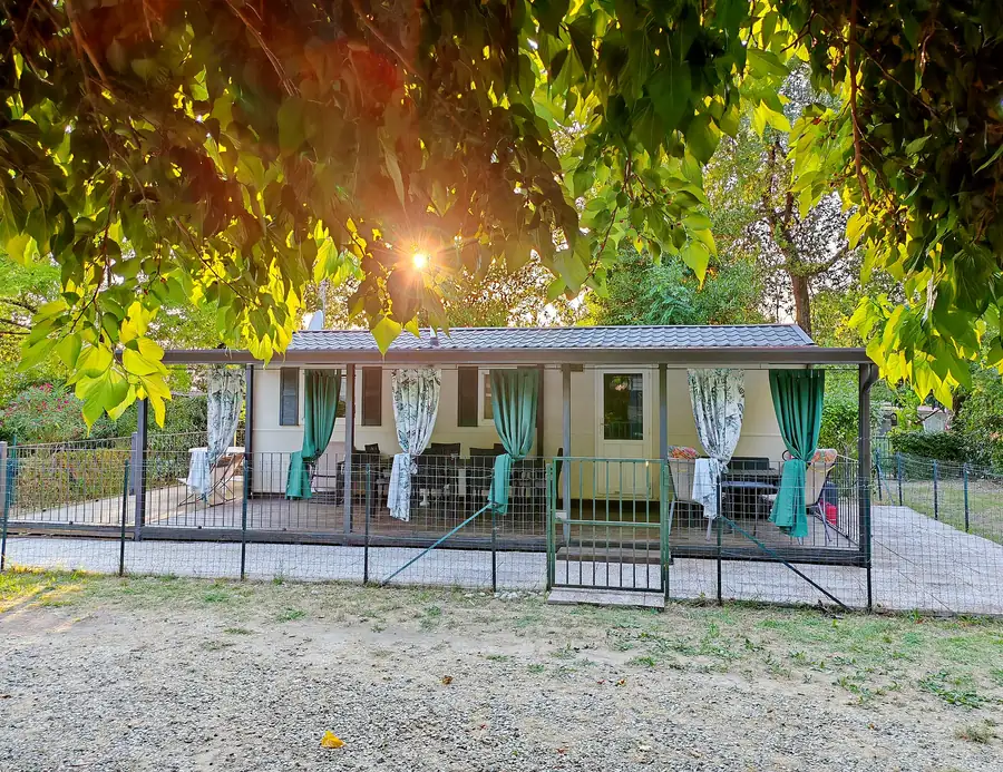 The mobile home under the mulberry tree, inside the resort